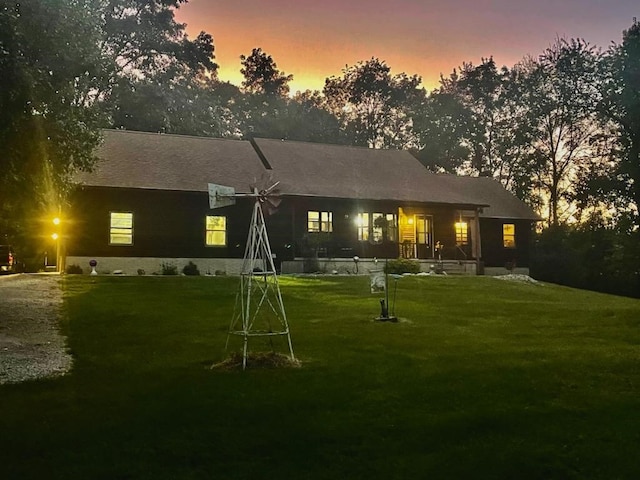 1901 42nd St SE, Cedar Rapids, IA 52403 - back of house at dusk featuring a lawn