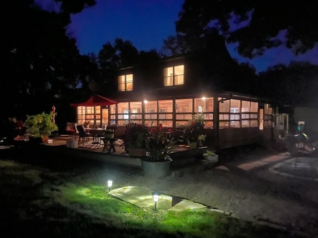 1901 42nd St SE, Cedar Rapids, IA 52403 - back of house at twilight featuring a patio area
