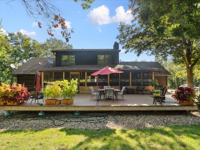 1901 42nd St SE, Cedar Rapids, IA 52403 - rear view of house with a chimney, a deck, and outdoor dining area