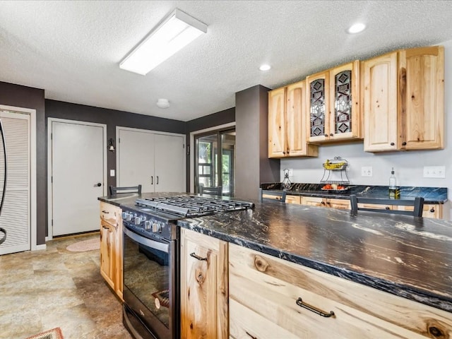 1901 42nd St SE, Cedar Rapids, IA 52403 - kitchen with stainless steel range with gas cooktop, light brown cabinets, a textured ceiling, glass insert cabinets, and recessed lighting