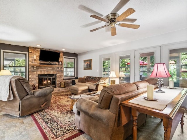 1901 42nd St SE, Cedar Rapids, IA 52403 - living area featuring a brick fireplace, a ceiling fan, and a textured ceiling