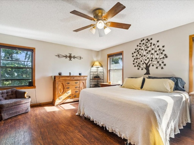 1901 42nd St SE, Cedar Rapids, IA 52403 - bedroom with wood finished floors, a textured ceiling, baseboards, and a ceiling fan