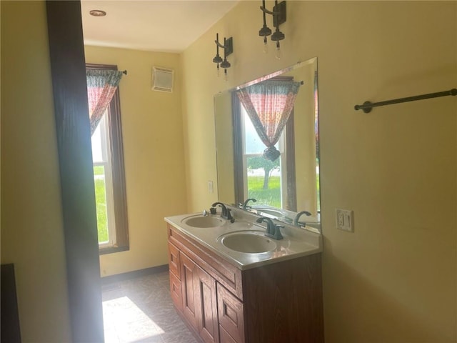 2902 Water St, Columbus City, IA 52737 - bathroom featuring double vanity and baseboards