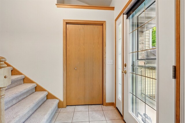 6967 Doubletree Rd NE, Cedar Rapids, IA 52402 - foyer with light tile patterned flooring, stairway, and baseboards