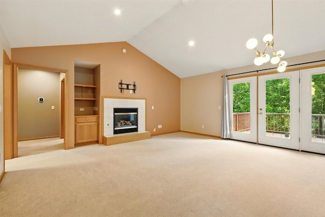 6967 Doubletree Rd NE, Cedar Rapids, IA 52402 - unfurnished living room with vaulted ceiling, built in shelves, light colored carpet, baseboards, and a chandelier