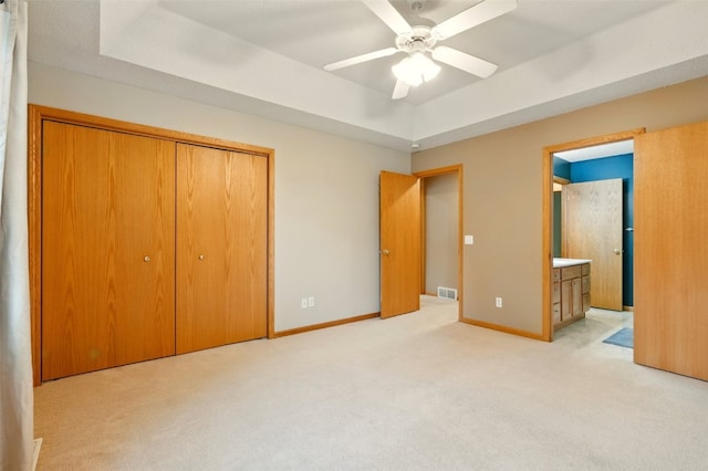 6967 Doubletree Rd NE, Cedar Rapids, IA 52402 - unfurnished bedroom featuring carpet floors, a raised ceiling, a closet, baseboards, and ensuite bath