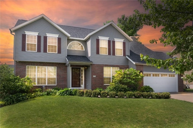 6919 Rockingham Dr SW, Cedar Rapids, IA 52404 - traditional home with brick siding, driveway, a yard, an attached garage, and roof with shingles