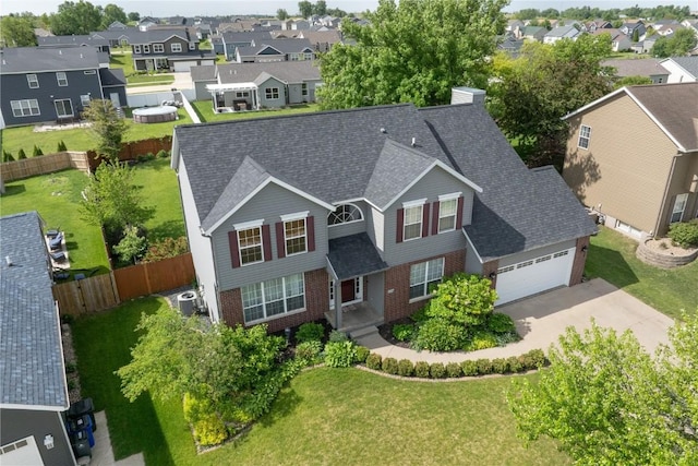 6919 Rockingham Dr SW, Cedar Rapids, IA 52404 - view of front of property with a residential view, concrete driveway, brick siding, a garage, and a shingled roof
