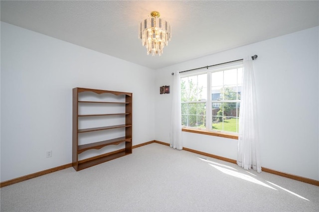 6919 Rockingham Dr SW, Cedar Rapids, IA 52404 - spare room with a chandelier, baseboards, and carpet flooring