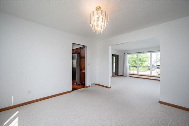 6919 Rockingham Dr SW, Cedar Rapids, IA 52404 - unfurnished room featuring a chandelier, light carpet, and baseboards