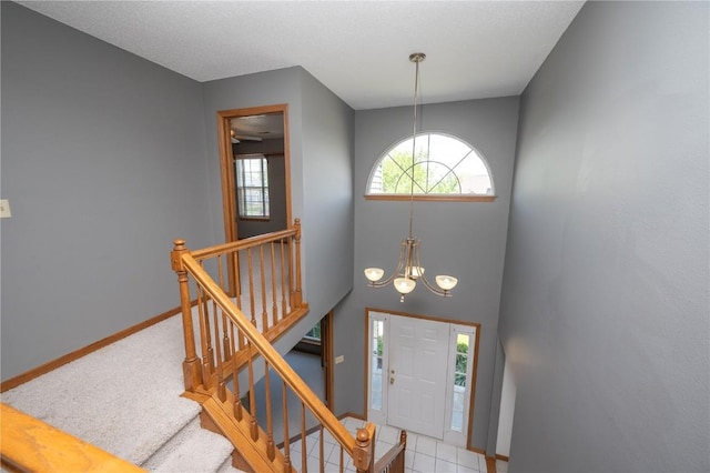 6919 Rockingham Dr SW, Cedar Rapids, IA 52404 - carpeted entryway featuring baseboards and a chandelier