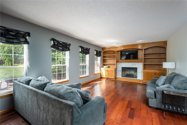 6919 Rockingham Dr SW, Cedar Rapids, IA 52404 - living room with a textured ceiling, hardwood / wood-style flooring, healthy amount of natural light, a fireplace, and baseboards