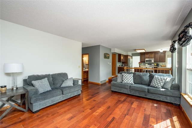 6919 Rockingham Dr SW, Cedar Rapids, IA 52404 - living room featuring dark wood-type flooring and baseboards