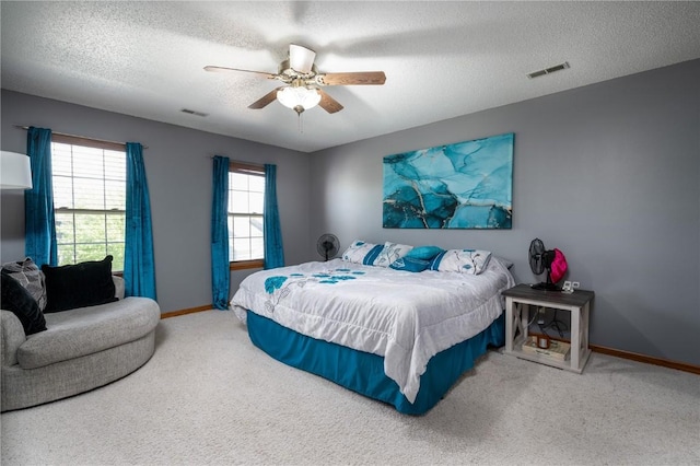 6919 Rockingham Dr SW, Cedar Rapids, IA 52404 - bedroom featuring carpet, a textured ceiling, baseboards, and ceiling fan