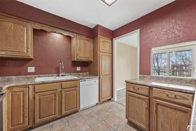 5712 Golden Ct NE Unit 60, Cedar Rapids, IA 52402 - kitchen with dishwasher, a sink, a textured wall, light tile patterned flooring, and brown cabinets