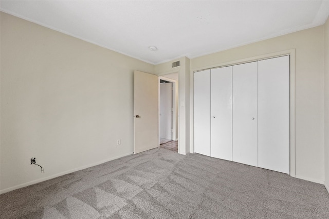 5712 Golden Ct NE Unit 60, Cedar Rapids, IA 52402 - unfurnished bedroom featuring carpet, a closet, and baseboards