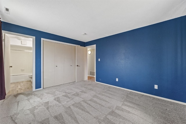 5712 Golden Ct NE Unit 60, Cedar Rapids, IA 52402 - unfurnished bedroom with carpet flooring, baseboards, ensuite bathroom, and a closet