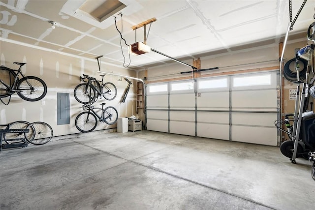 927 Summit Ct, Tiffin, IA 52340 - garage featuring electric panel and a garage door opener