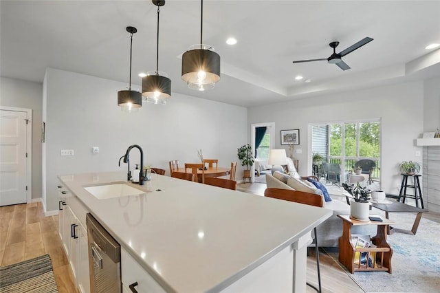 927 Summit Ct, Tiffin, IA 52340 - kitchen featuring a sink, stainless steel dishwasher, ceiling fan, light countertops, and white cabinetry