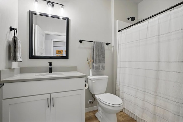 927 Summit Ct, Tiffin, IA 52340 - bathroom featuring toilet, vanity, wood finished floors, and a shower with shower curtain