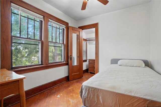 715 E Market St, Iowa City, IA 52245 - bedroom featuring baseboards, hardwood / wood-style floors, and a ceiling fan