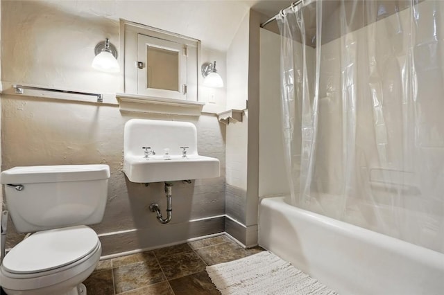 715 E Market St, Iowa City, IA 52245 - full bath featuring toilet, shower / bath combination with curtain, and stone finish flooring