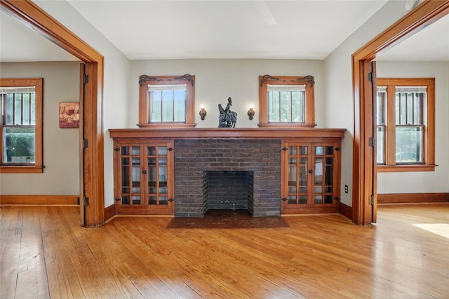 715 E Market St, Iowa City, IA 52245 - living room featuring wood-type flooring, baseboards, and a fireplace