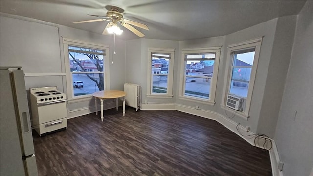 728 4th Ave SE, Cedar Rapids, IA 52401 - dining space with radiator, dark wood-style floors, a ceiling fan, and baseboards
