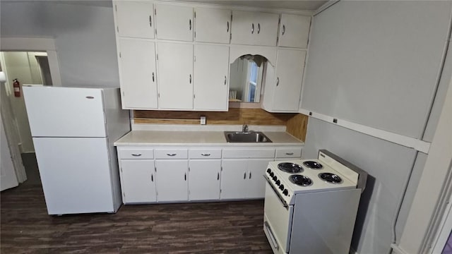 728 4th Ave SE, Cedar Rapids, IA 52401 - kitchen featuring white appliances, light countertops, a sink, and white cabinets