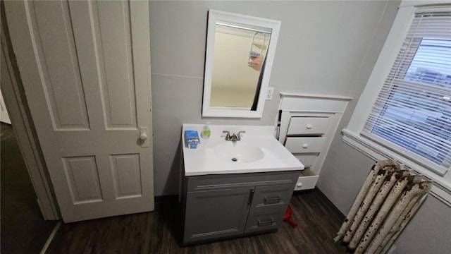 728 4th Ave SE, Cedar Rapids, IA 52401 - half bathroom with wood finished floors, vanity, and radiator heating unit