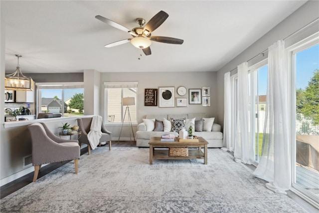 5150 Prairie Ridge Dr, Marion, IA 52302 - living room featuring healthy amount of natural light, a chandelier, and a ceiling fan