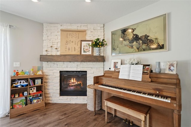 5150 Prairie Ridge Dr, Marion, IA 52302 - sitting room with wood finished floors, a fireplace, and recessed lighting