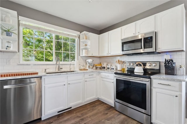 5150 Prairie Ridge Dr, Marion, IA 52302 - kitchen with stainless steel appliances, open shelves, a sink, decorative backsplash, and white cabinets