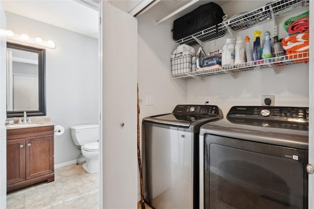 5150 Prairie Ridge Dr, Marion, IA 52302 - washroom with washing machine and clothes dryer and baseboards
