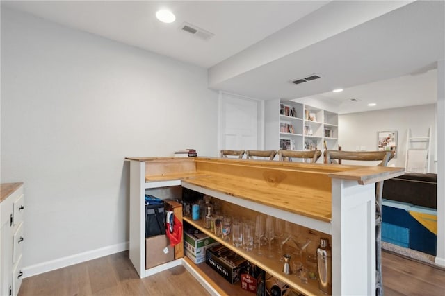 5150 Prairie Ridge Dr, Marion, IA 52302 - bar with wood finished floors, baseboards, and recessed lighting