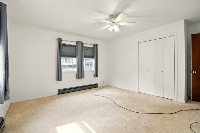 113 Chaffee Dr, Hiawatha, IA 52233 - unfurnished bedroom with a baseboard heating unit, carpet flooring, a closet, and a ceiling fan