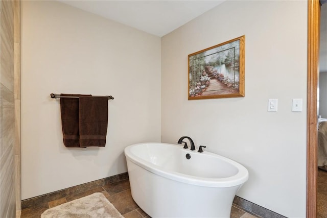 2545 F52 Trl, Parnell, IA 52325 - full bath featuring a freestanding bath, baseboards, and stone tile floors