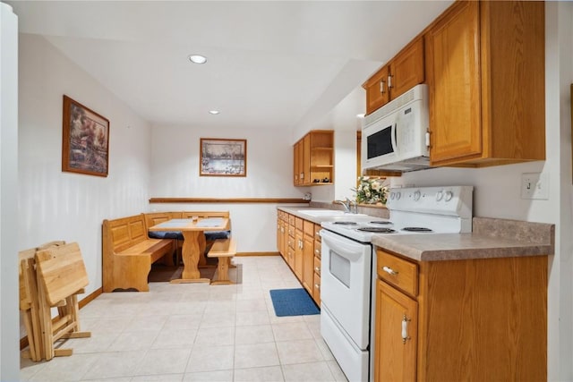 2545 F52 Trl, Parnell, IA 52325 - kitchen featuring white appliances, open shelves, baseboards, a sink, and brown cabinets
