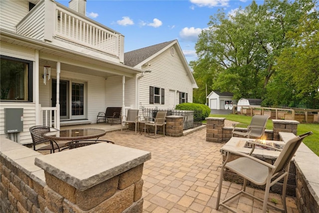 2545 F52 Trl, Parnell, IA 52325 - view of patio / terrace featuring an outdoor fire pit and a balcony