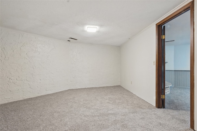 1004 W Welsh St, Williamsburg, IA 52361 - carpeted empty room with a textured wall, crown molding, and a textured ceiling