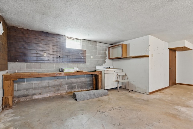 1004 W Welsh St, Williamsburg, IA 52361 - below grade area with concrete block wall and a textured ceiling