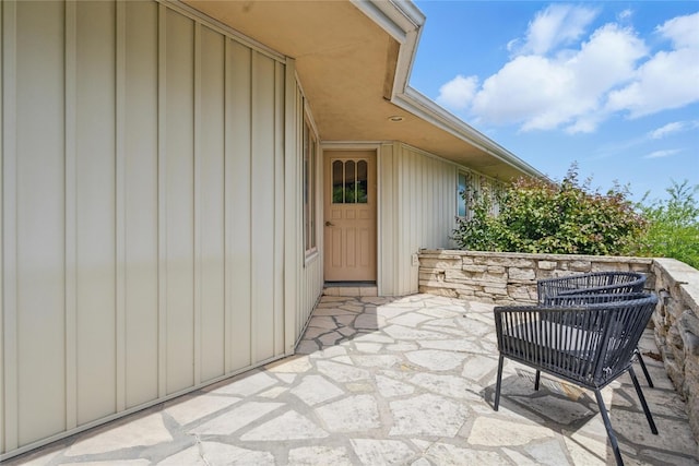 1004 W Welsh St, Williamsburg, IA 52361 - view of exterior entry with board and batten siding and a patio area
