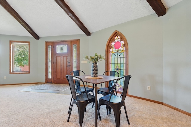 1004 W Welsh St, Williamsburg, IA 52361 - dining space featuring light carpet, beamed ceiling, baseboards, and a textured ceiling