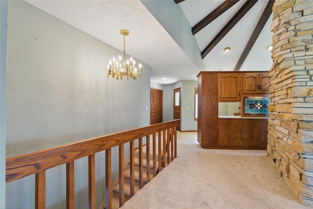 1004 W Welsh St, Williamsburg, IA 52361 - corridor with light colored carpet and a chandelier