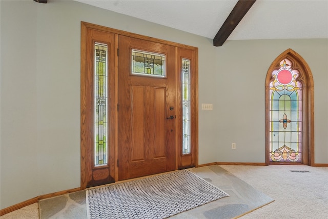 1004 W Welsh St, Williamsburg, IA 52361 - carpeted foyer featuring baseboards, beam ceiling, and arched walkways
