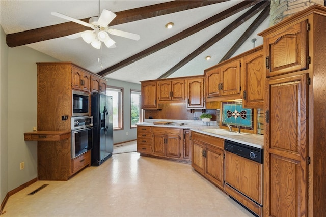 1004 W Welsh St, Williamsburg, IA 52361 - kitchen featuring dishwasher, wall oven, black fridge, stainless steel microwave, and brown cabinetry