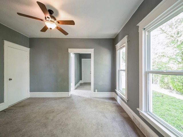 280 14th Ave SW, Cedar Rapids, IA 52404 - carpeted spare room featuring healthy amount of natural light, a ceiling fan, and baseboards