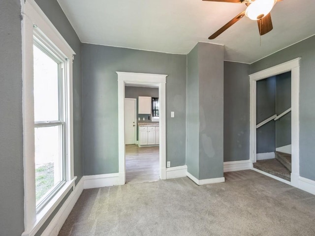 280 14th Ave SW, Cedar Rapids, IA 52404 - unfurnished bedroom with carpet floors, baseboards, and a ceiling fan