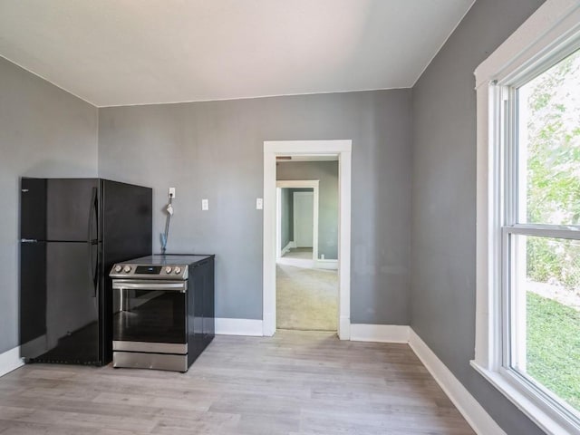280 14th Ave SW, Cedar Rapids, IA 52404 - kitchen featuring stainless steel electric range oven, freestanding refrigerator, light wood finished floors, and baseboards