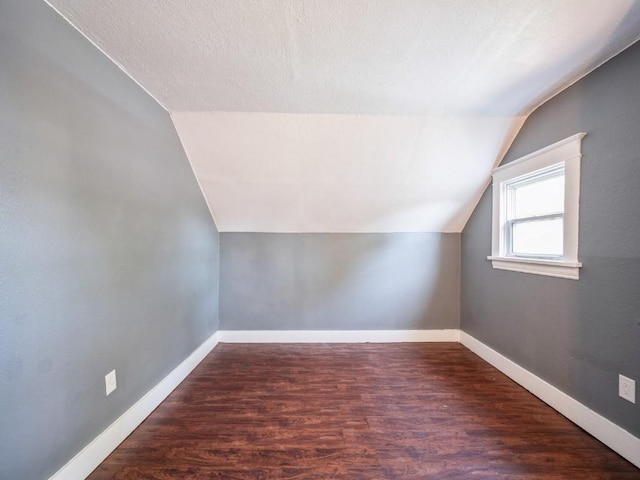 280 14th Ave SW, Cedar Rapids, IA 52404 - bonus room with vaulted ceiling, wood finished floors, and baseboards